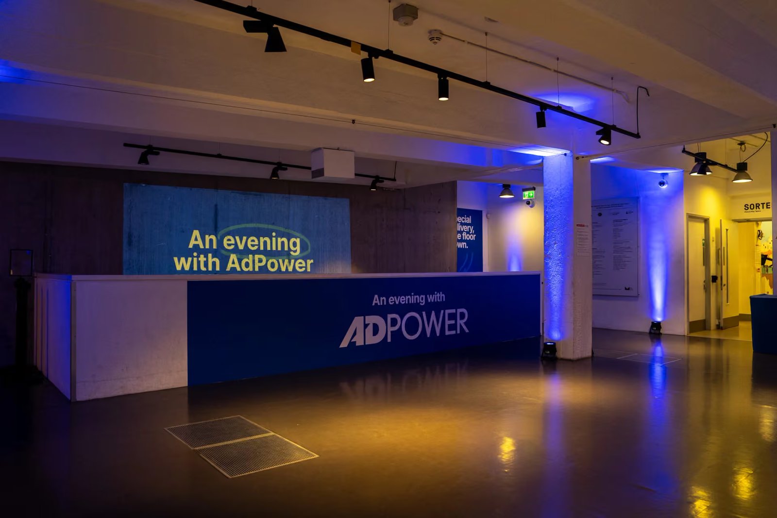 AdPower branding across the low wall in the welcome space