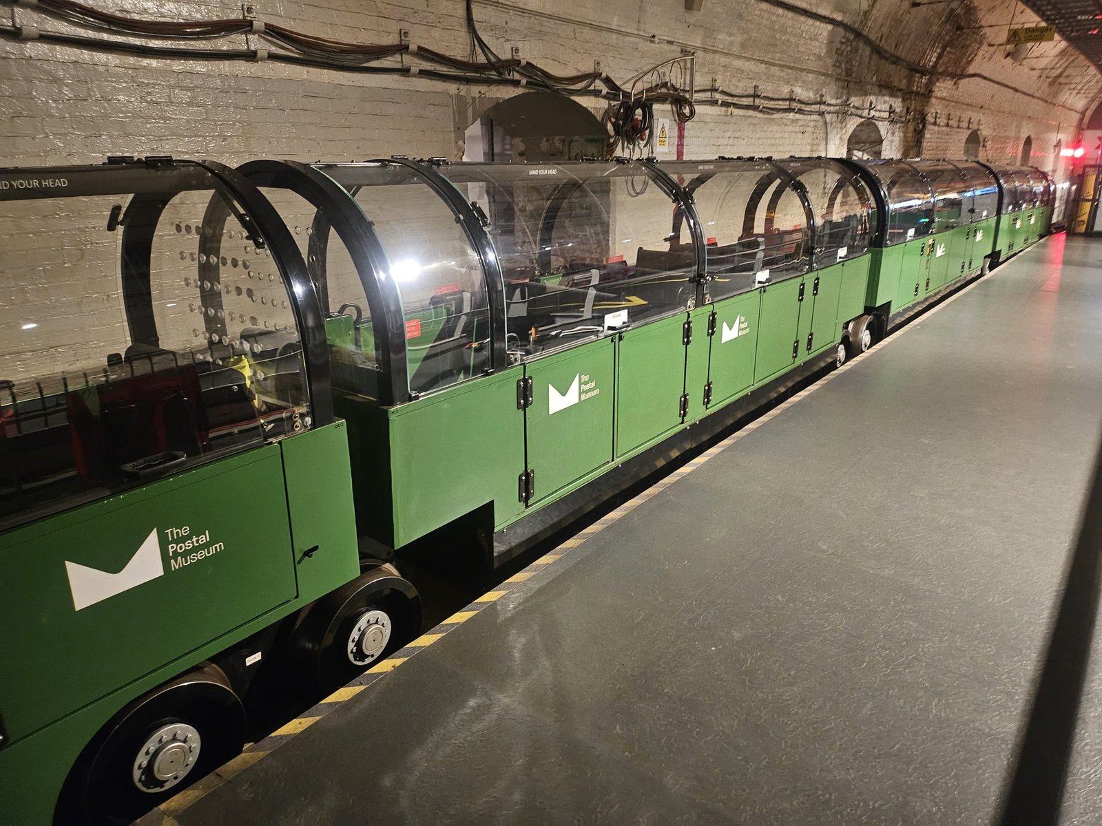 The Mail Rail trains on the platform beside the event