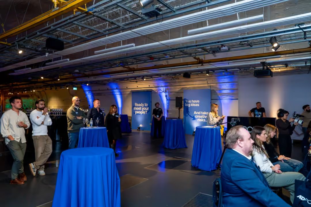 Guests networking beside the printed AdPower panels