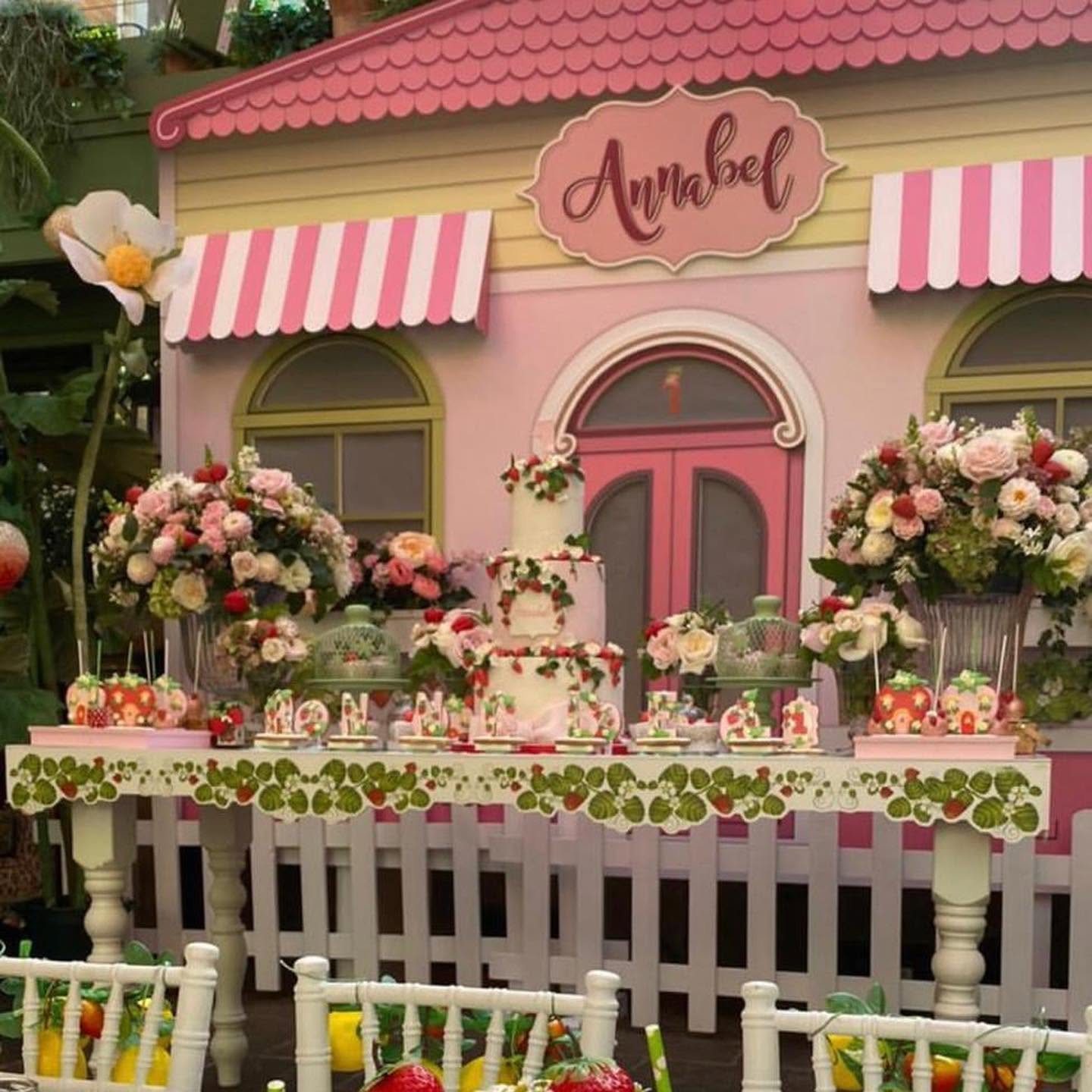 The dessert table in front of the house, with its printed strawberry vine table front