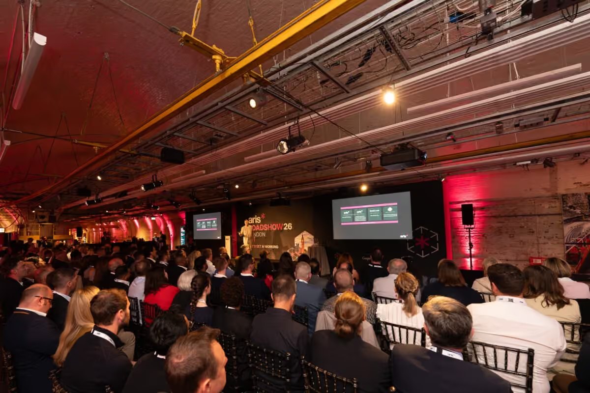A packed tunnel of delegates facing the ARIS Roadshow stage