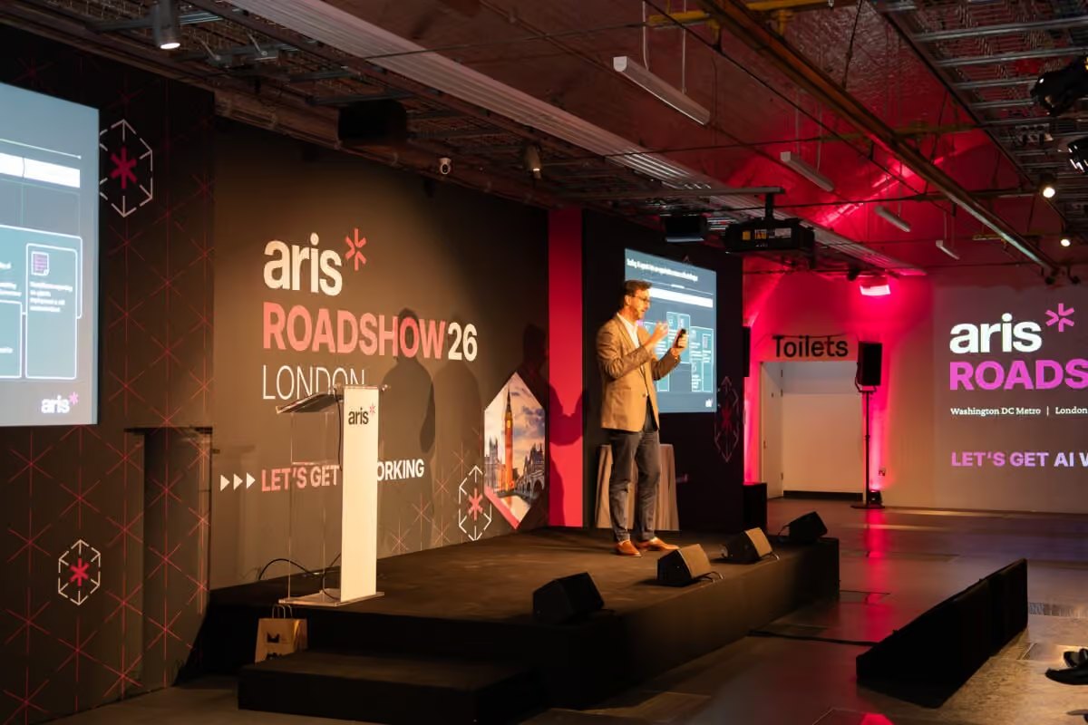 ARIS Roadshow 26 London stage with branded walls and a keynote speaker in the Mail Rail tunnel
