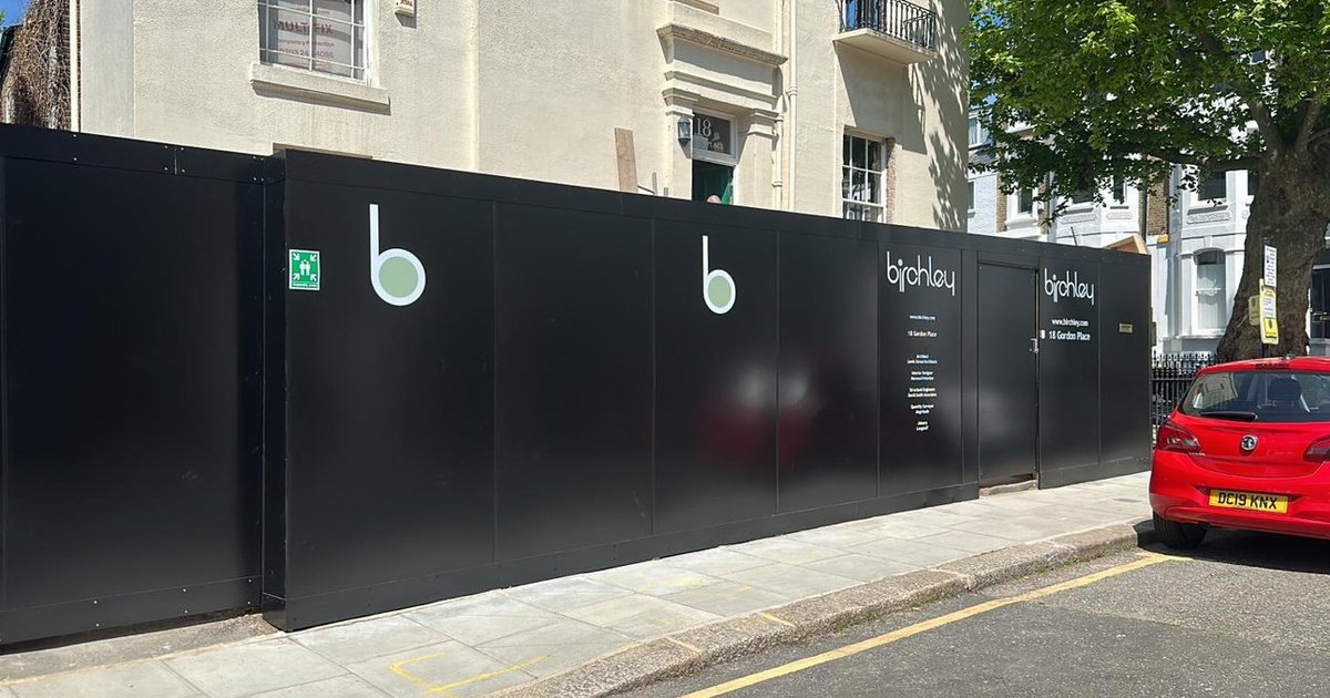 Black printed ACM site hoarding for Birchley on a London street