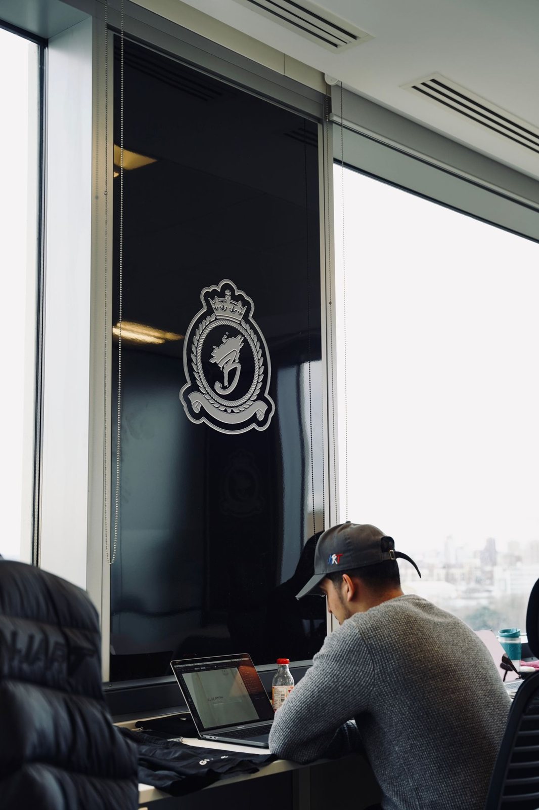 The Benjart crest manifestation on the glass, above the design desk