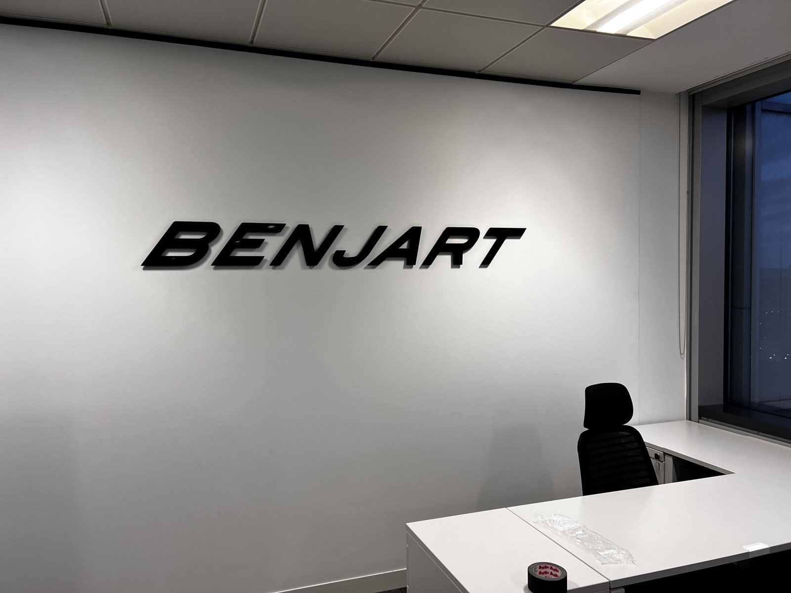 The BENJART letters on the design room wall above the desks