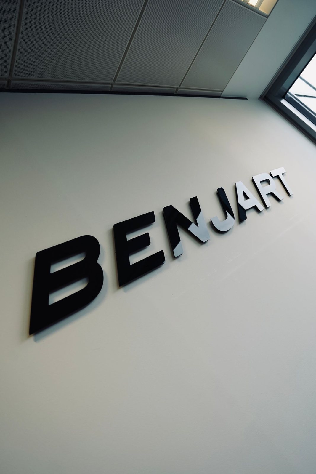 BENJART 3D letters cut from black gloss acrylic on the design room wall