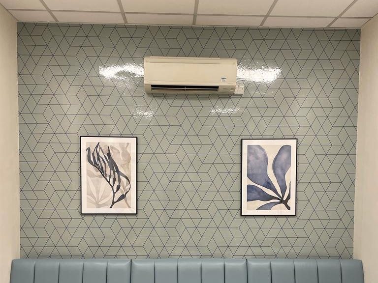 Printed geometric antibacterial wallpaper in an NHS staff breakout room
