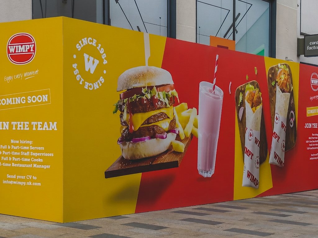 Printed WIMPY hoarding wrapping the corner of the Bracknell storefront