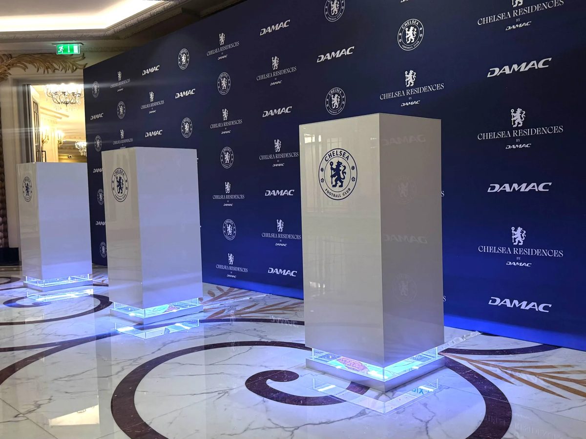Chelsea Residences by DAMAC media wall with lit Chelsea FC branded plinths
