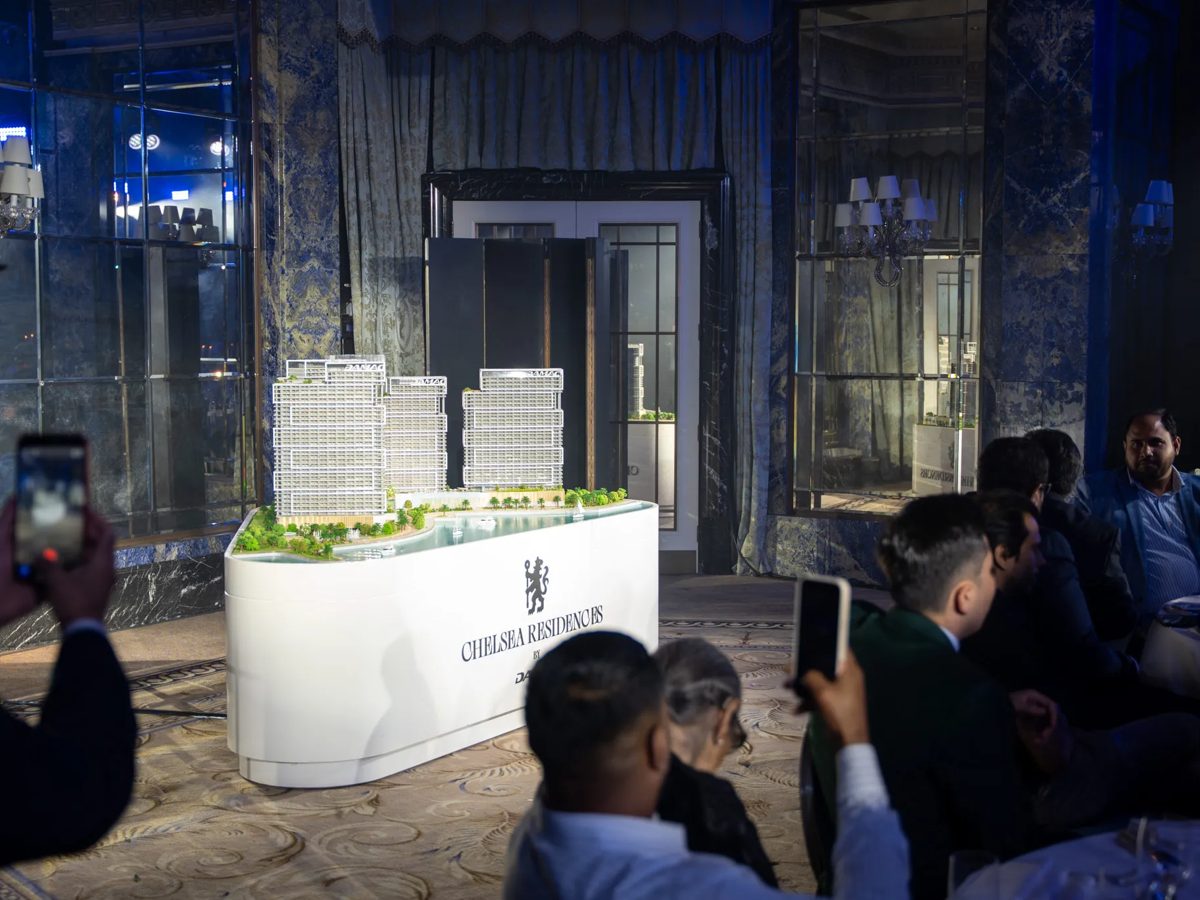 Scale model reveal on a Chelsea Residences branded plinth