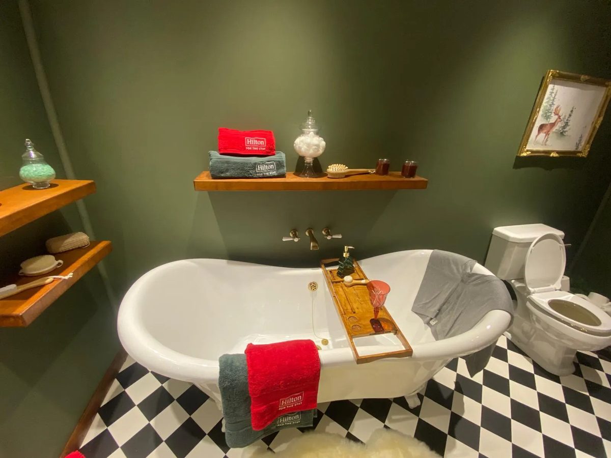 Hilton branded bathroom set with roll top bath and chequerboard floor