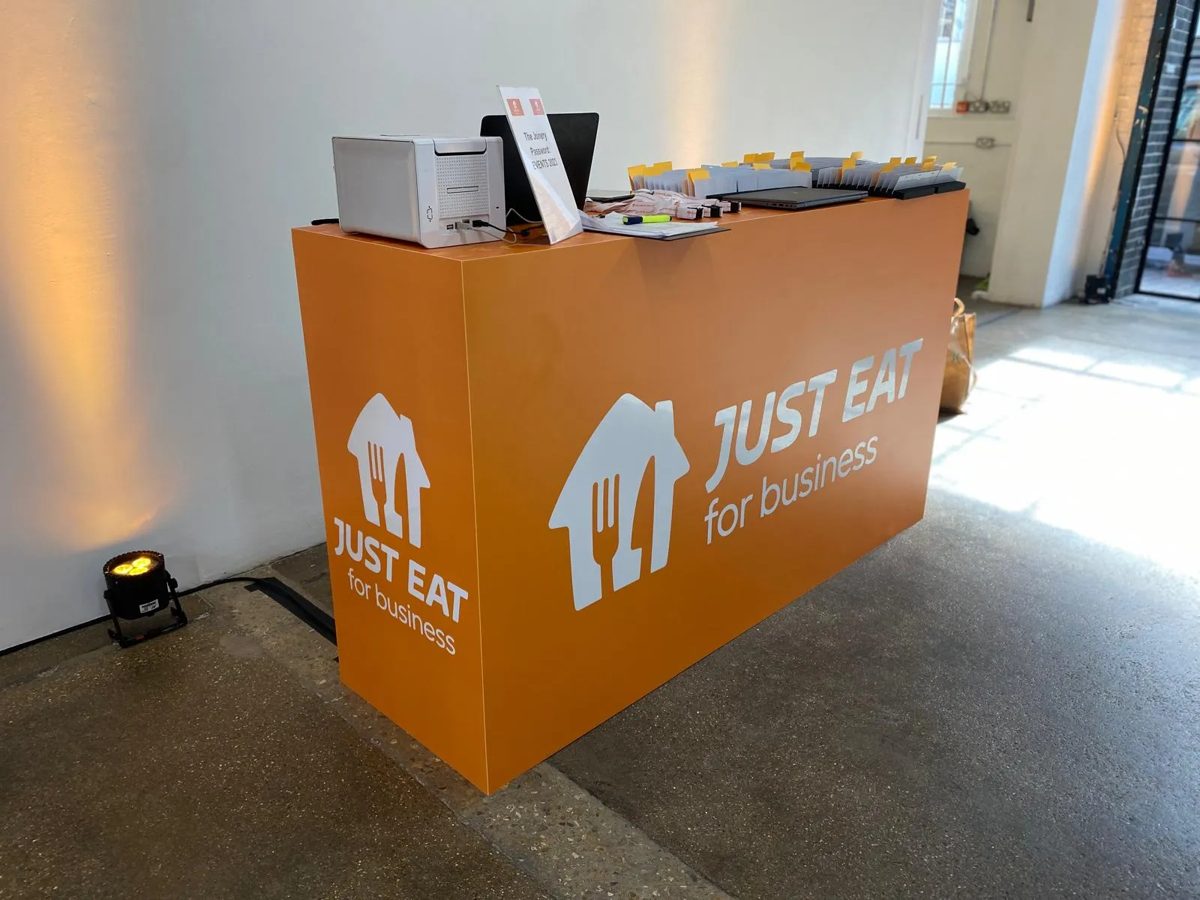 Orange wrapped Just Eat for Business registration counter