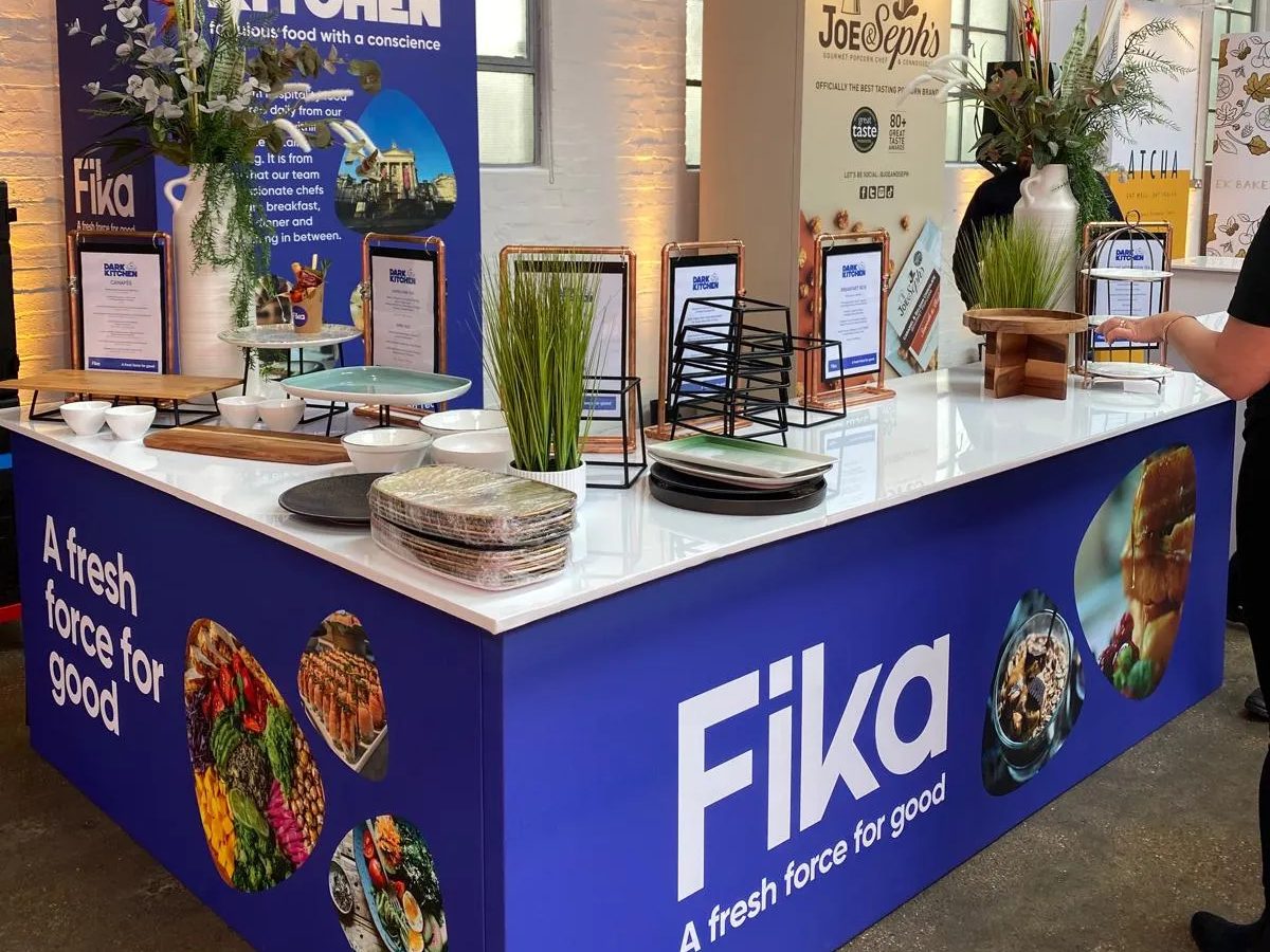 Fika food counter wrap with printed tower behind