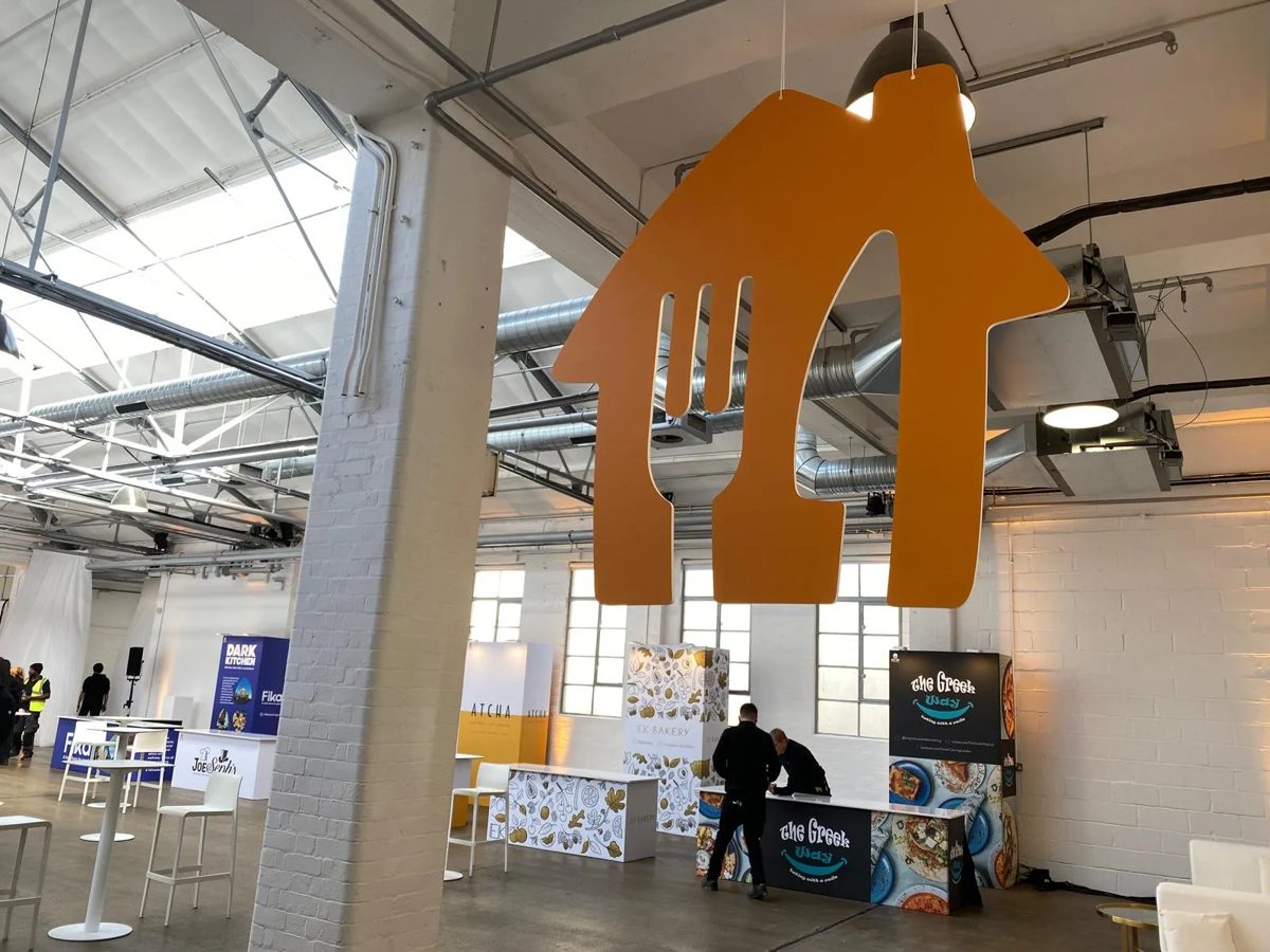 Giant cut Just Eat logo suspended over the event floor