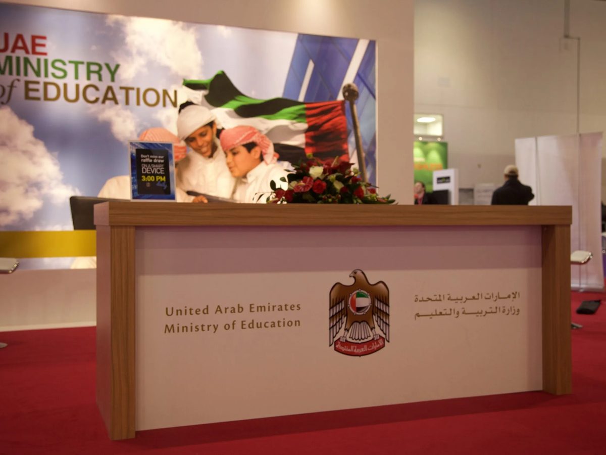 Branded reception desk with the UAE crest