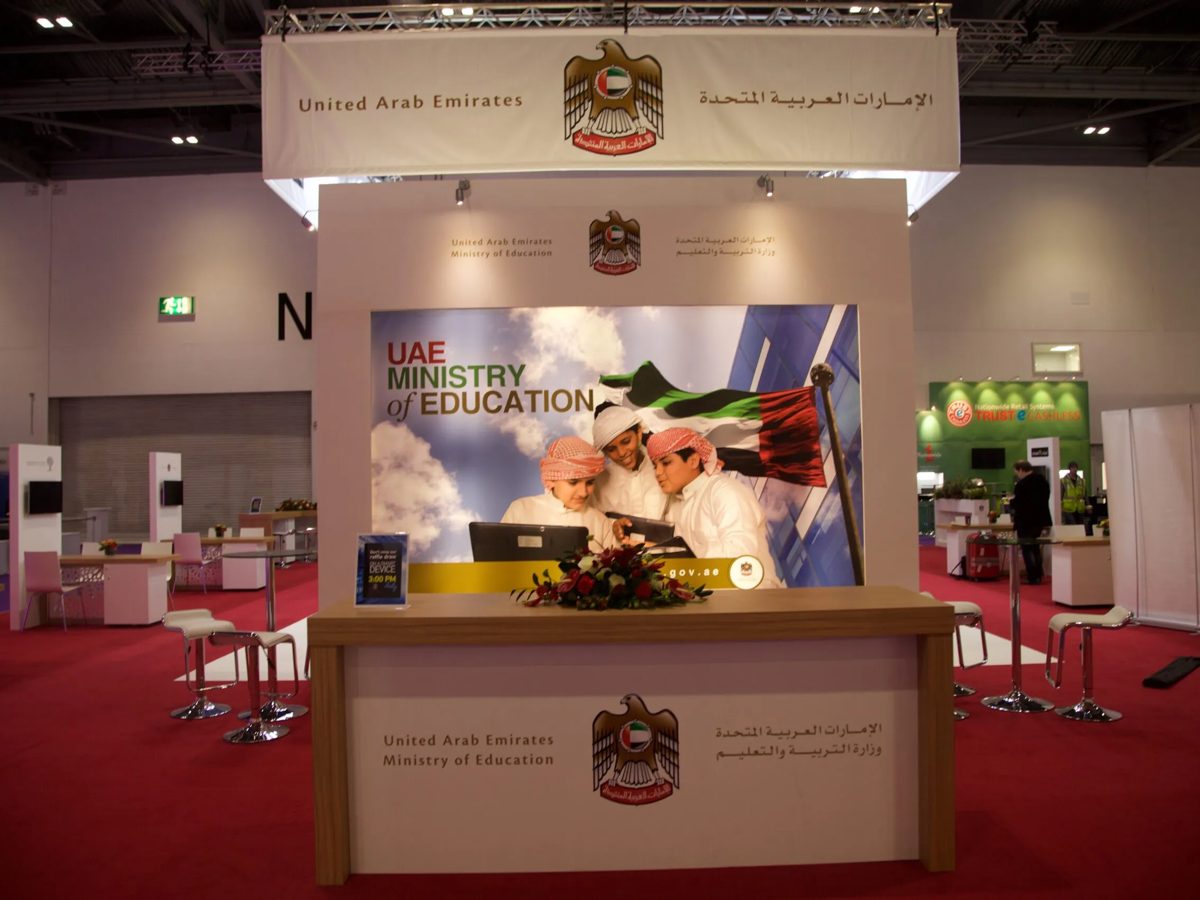 Front of the stand with hanging banner, printed backdrop and branded desk