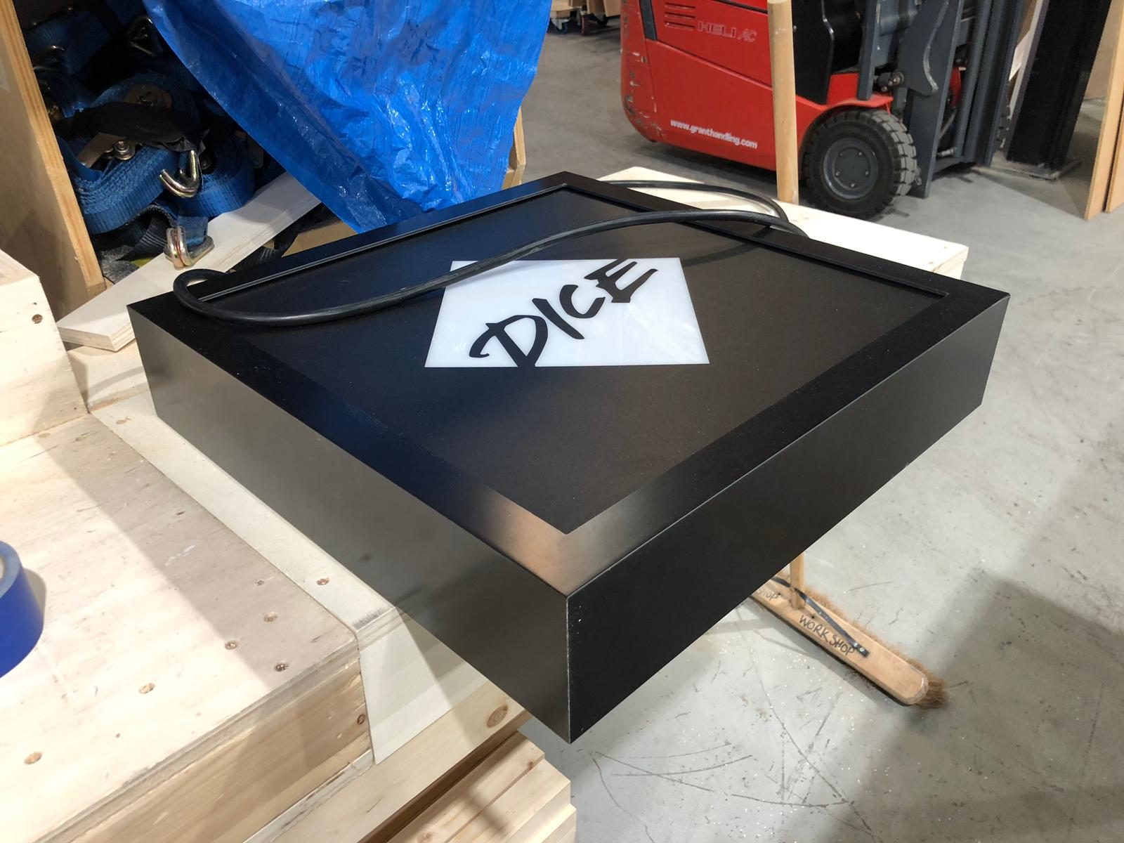 The DICE logo lightbox, finished in matt black and ready to ship