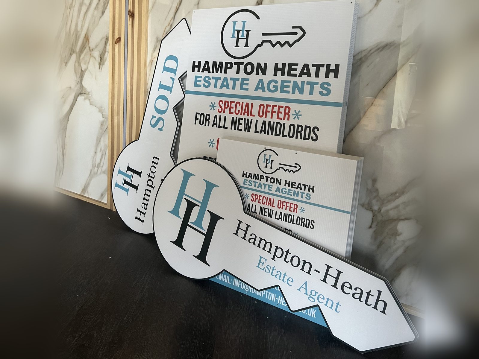 Printed estate agent boards and key shaped Sold signs
