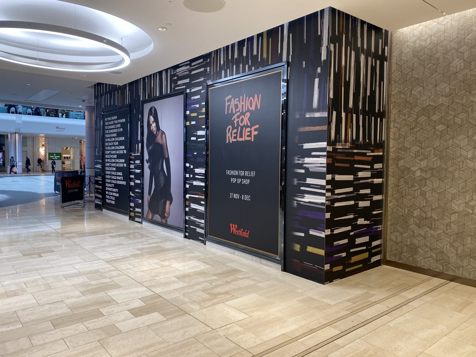 Branded artwork wrapping the Fashion for Relief storefront at Westfield London