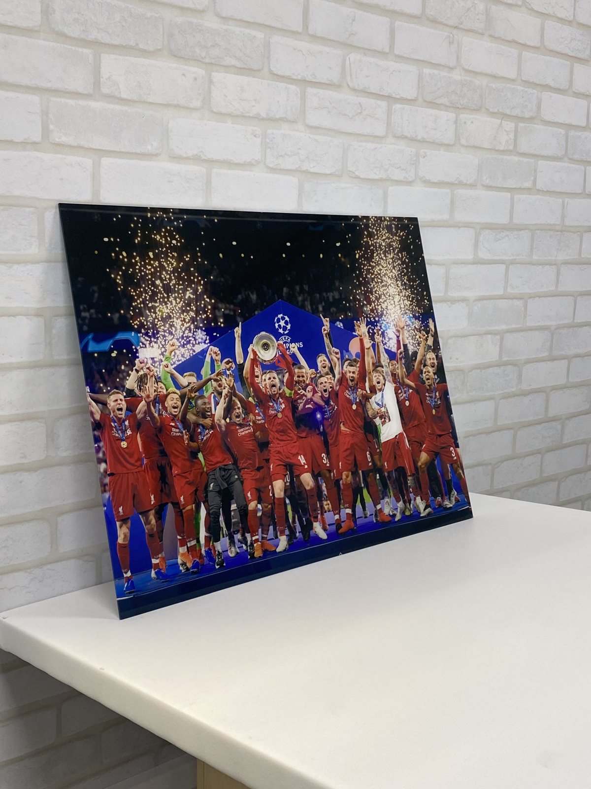 A0 gloss acrylic print of a football team lifting the Champions League trophy under a shower of golden fireworks