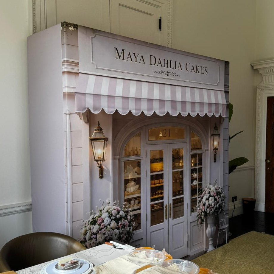 Custom UV Blackback Textile (Canvas) wrapped media board printed as a pastel pink Parisian cake shop front for Maya Dahlia Cakes at the Grove Hotel, Watford