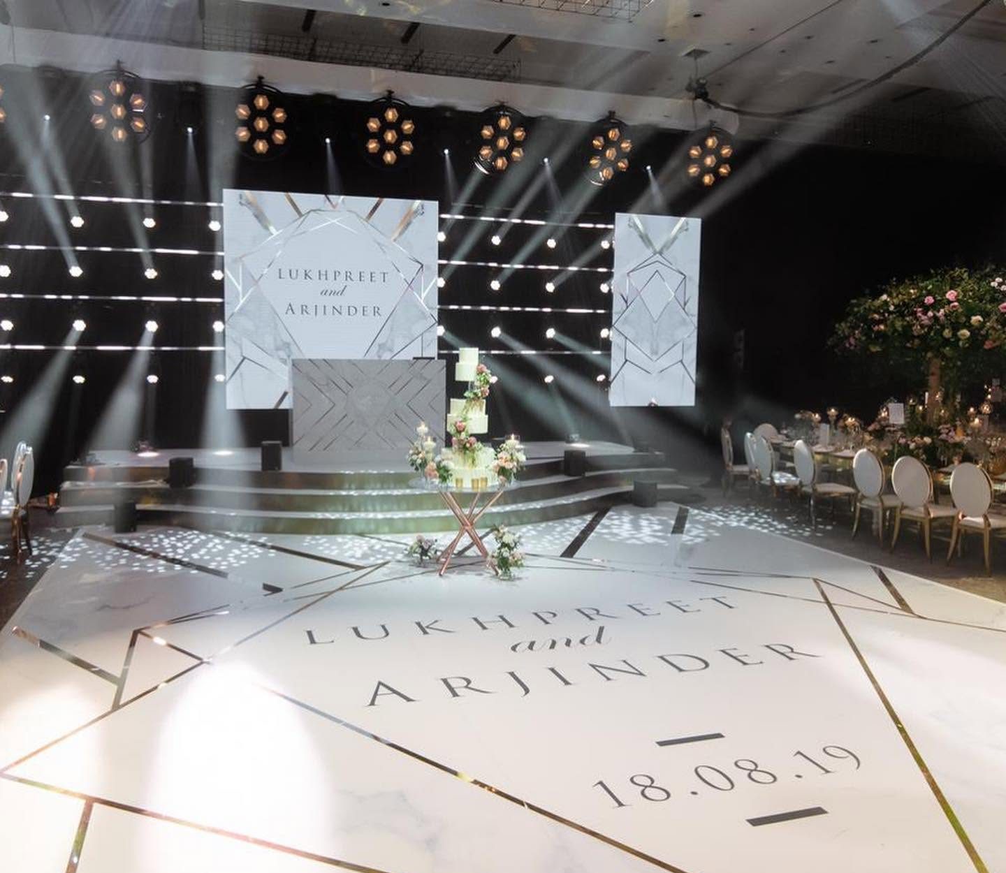 Wedding dance floor in brilliant white marble with gold mirror geometric lines revealed through the print and the couple's names and date in the centre