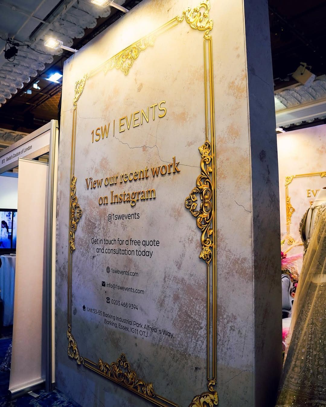 1SW Events exhibition stand wall wrapped in printed canvas with a distressed plaster effect and ornate gold baroque frame