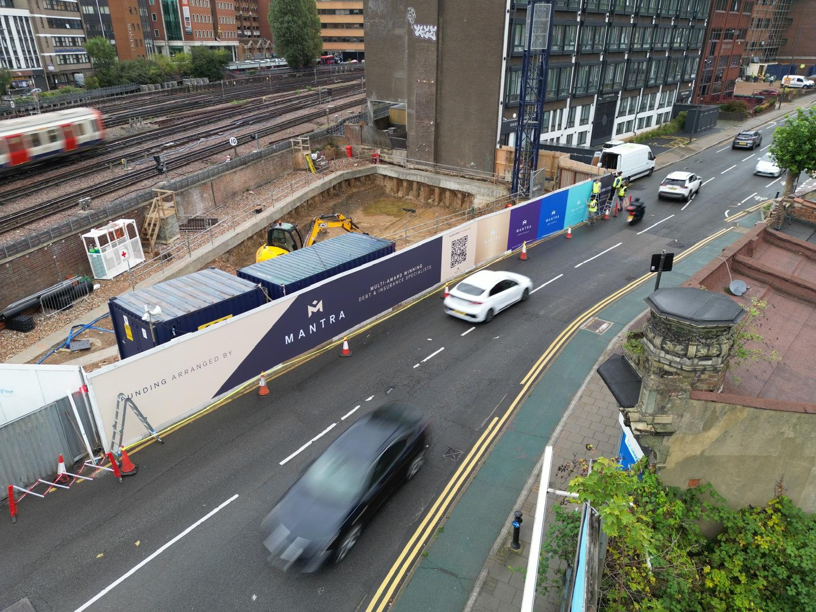 Aerial view of the Mantra printed hoarding running the length of the street