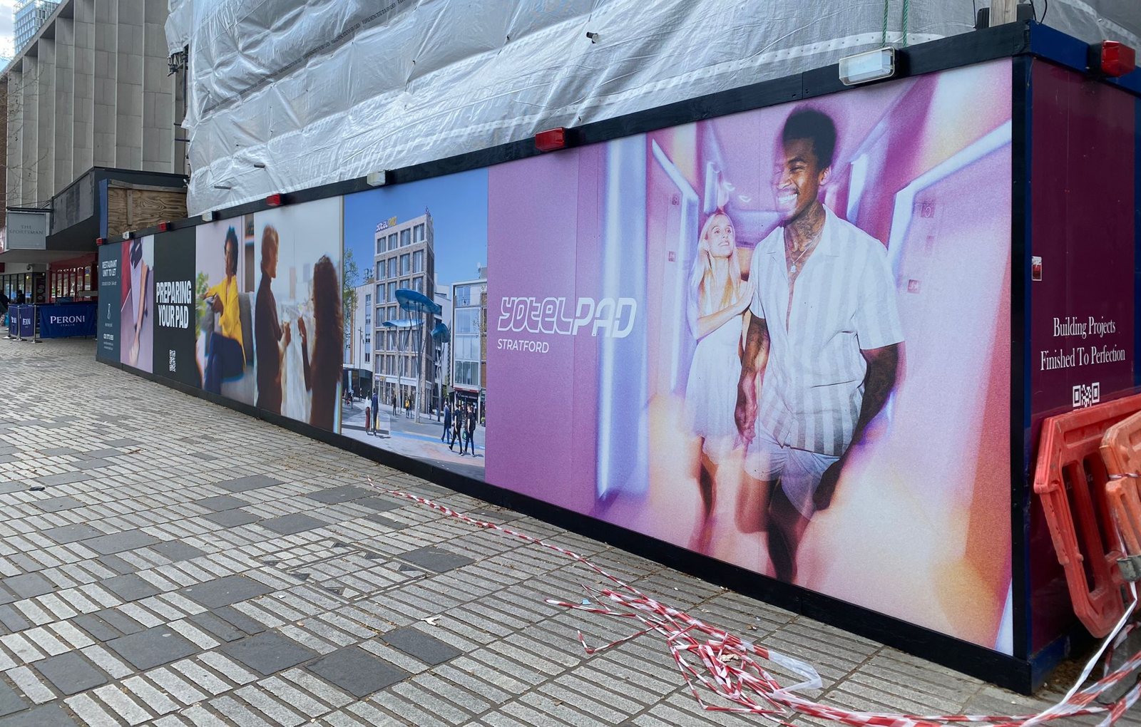 Printed YOTELPAD hoarding wrapping a corner site in Stratford, London