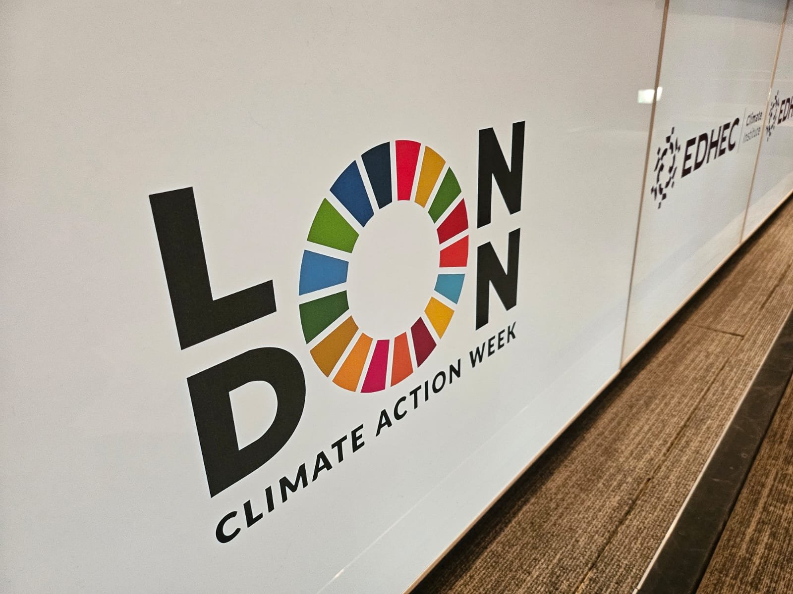 London Climate Action Week desk graphics in the EDHEC auditorium