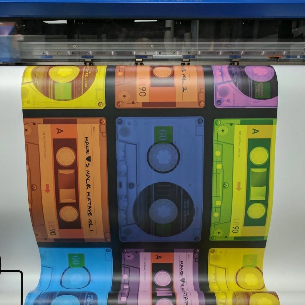 Wall vinyl printed with rainbow coloured cassette tapes reading Mansi loves Malik mixtape coming off a wide format printer