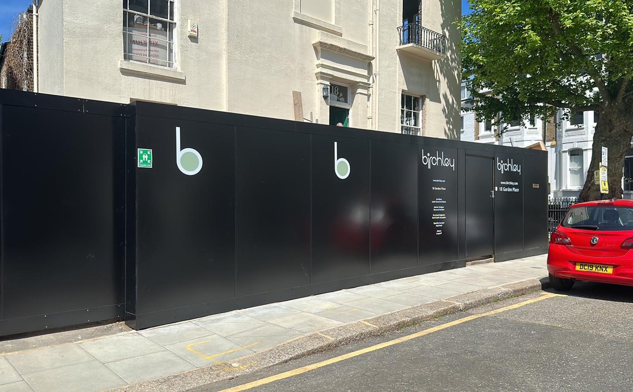 Black printed Birchley site hoarding at 18 Gordon Place, London