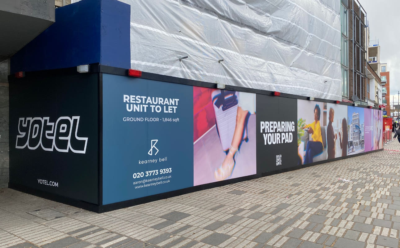 Printed Yotel site hoarding wrapping a building under construction