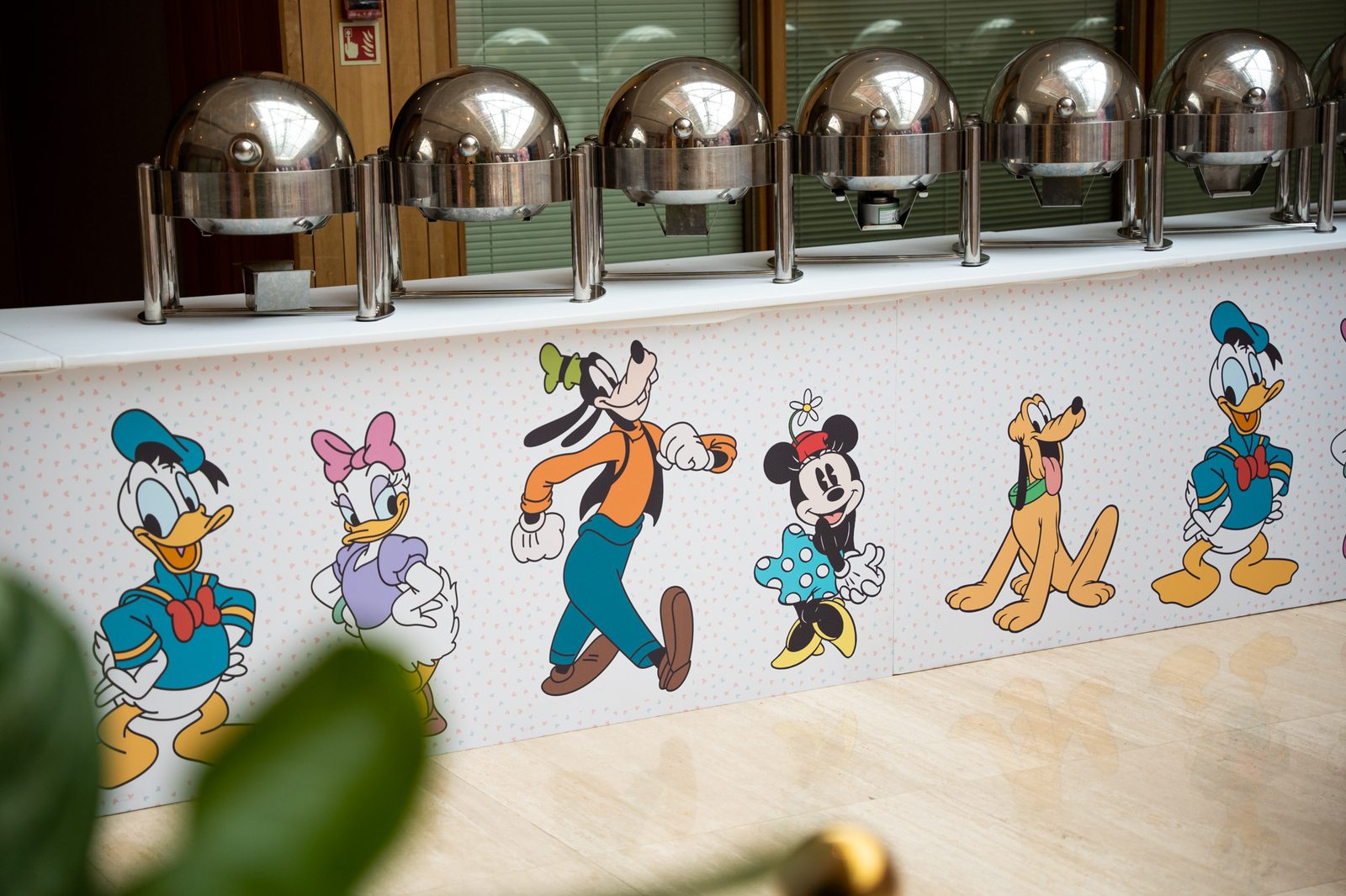 Close up of the printed Disney character buffet counter fascia at a kids birthday party