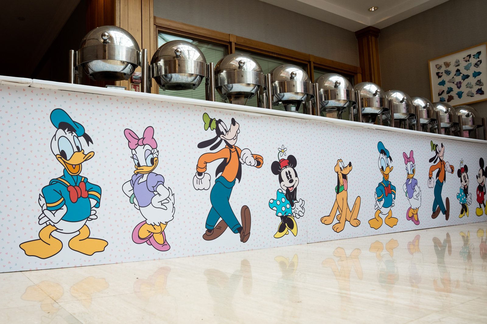 Printed buffet counter fascia with Mickey, Minnie, Donald, Daisy, Goofy and Pluto characters