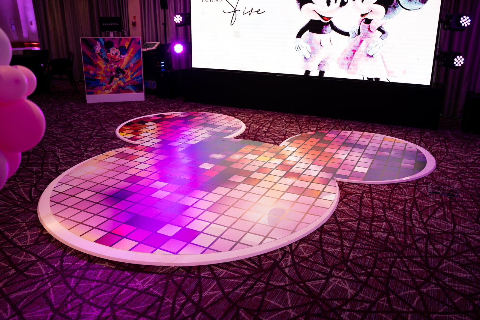 Custom Mickey head shaped dance floor with a printed disco tile design