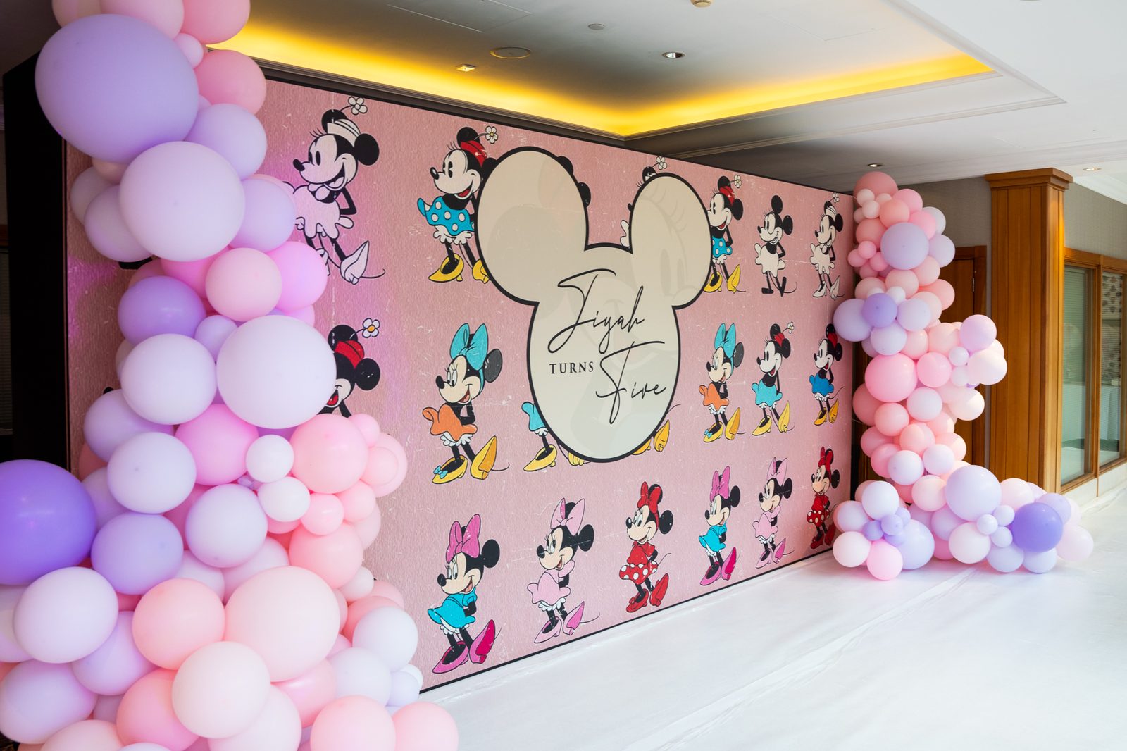 Pink Minnie Mouse printed photo backdrop for a kids party, seen from the side