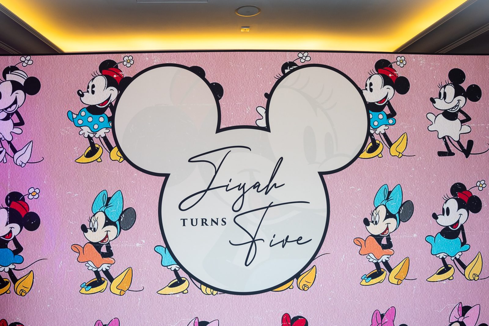Printed Minnie Mouse kids party backdrop with the personalised Mickey head centrepiece