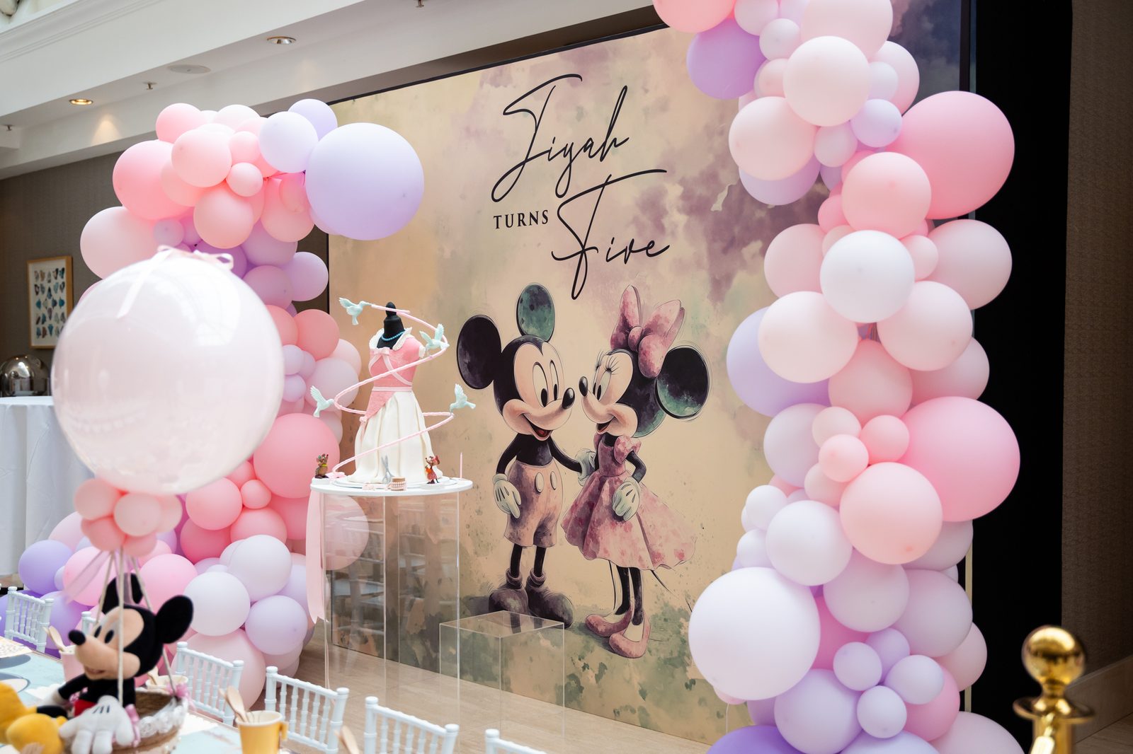 Watercolour Mickey and Minnie printed party backdrop with a personalised Jiyah turns Five script