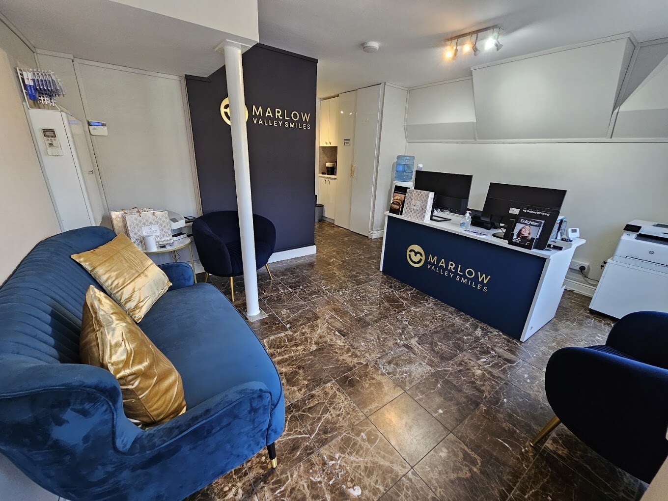 The finished Marlow Valley Smiles waiting room with the new branded reception desk and navy feature wall