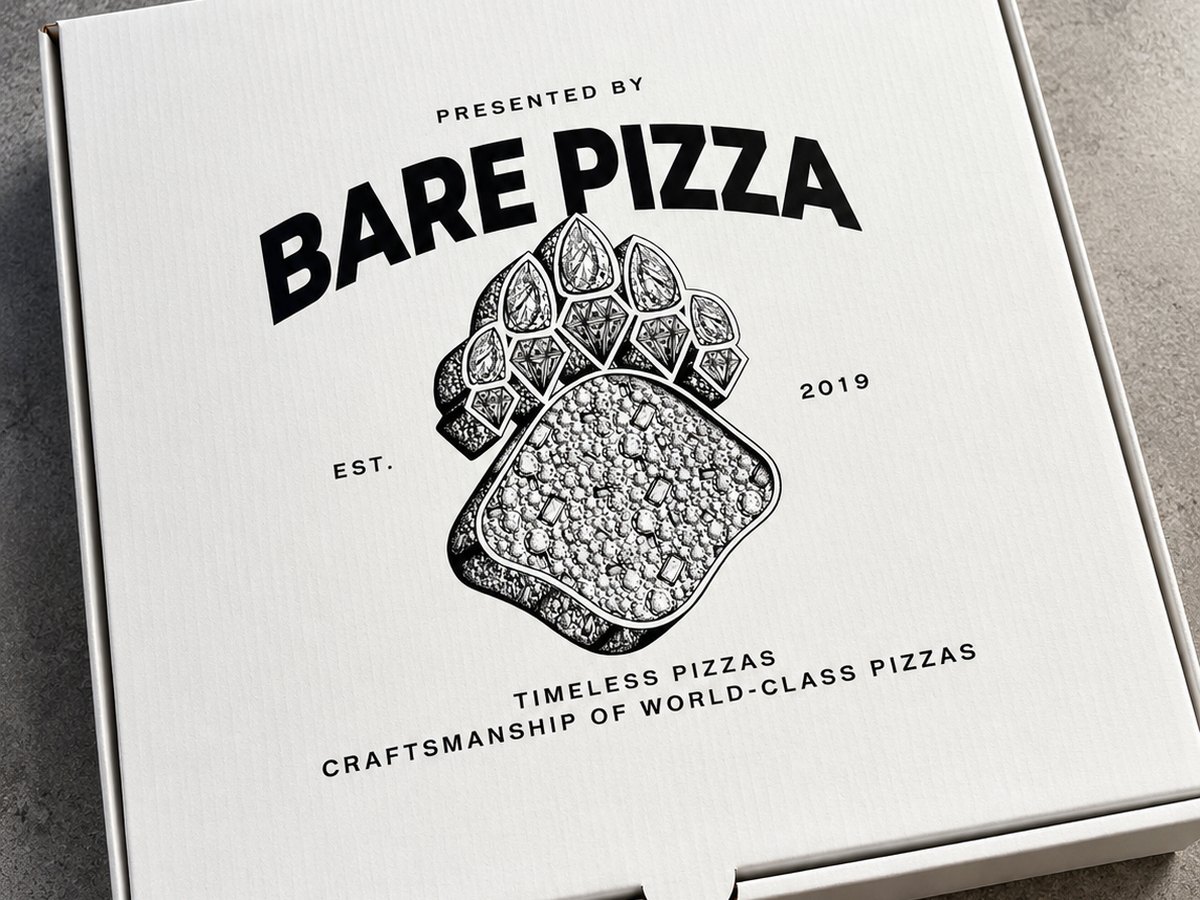 Custom printed Bare Pizza box with a jewelled paw illustration on a concrete floor