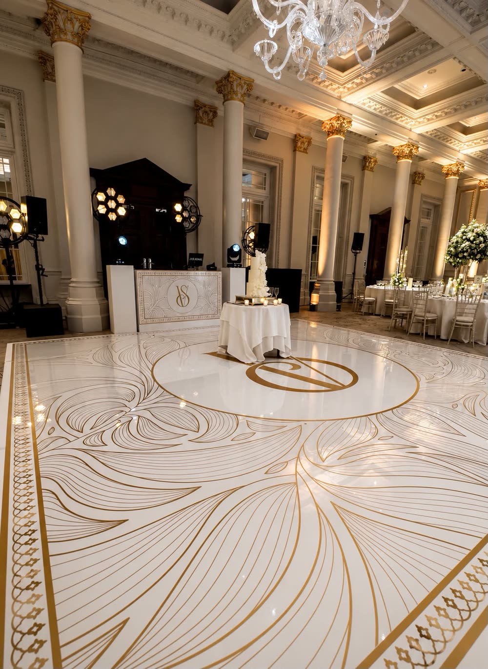 Gold and white printed dance floor with a monogram at a wedding