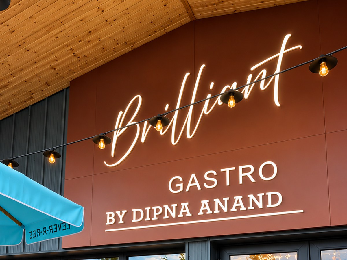 Illuminated Brilliant Gastro by Dipna Anand sign above a restaurant entrance
