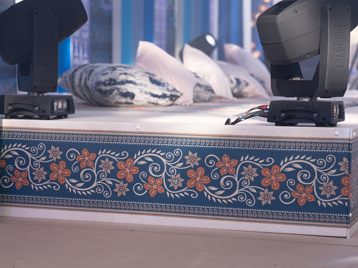 Event stage wrapped in a printed blue and coral floral fascia