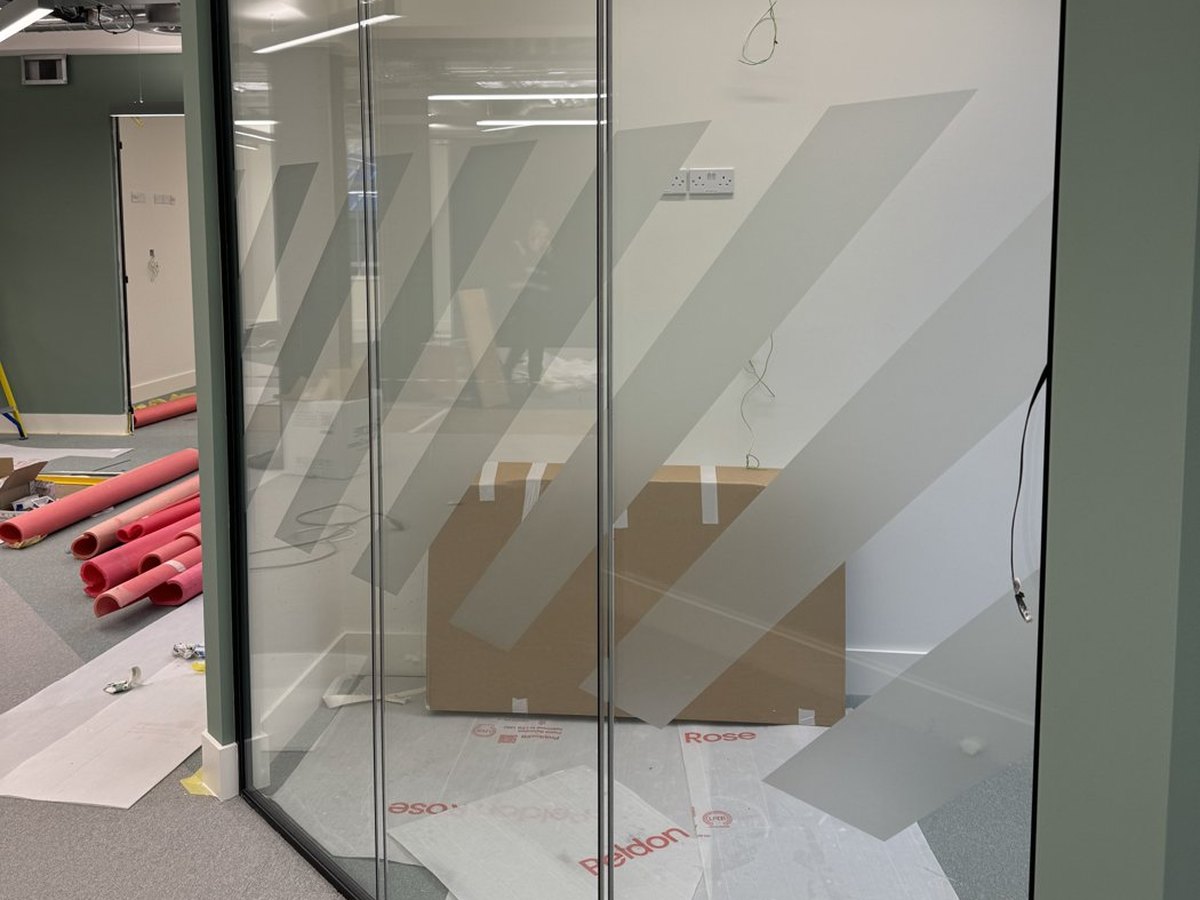 Frosted window film with diagonal stripes on an office glass partition