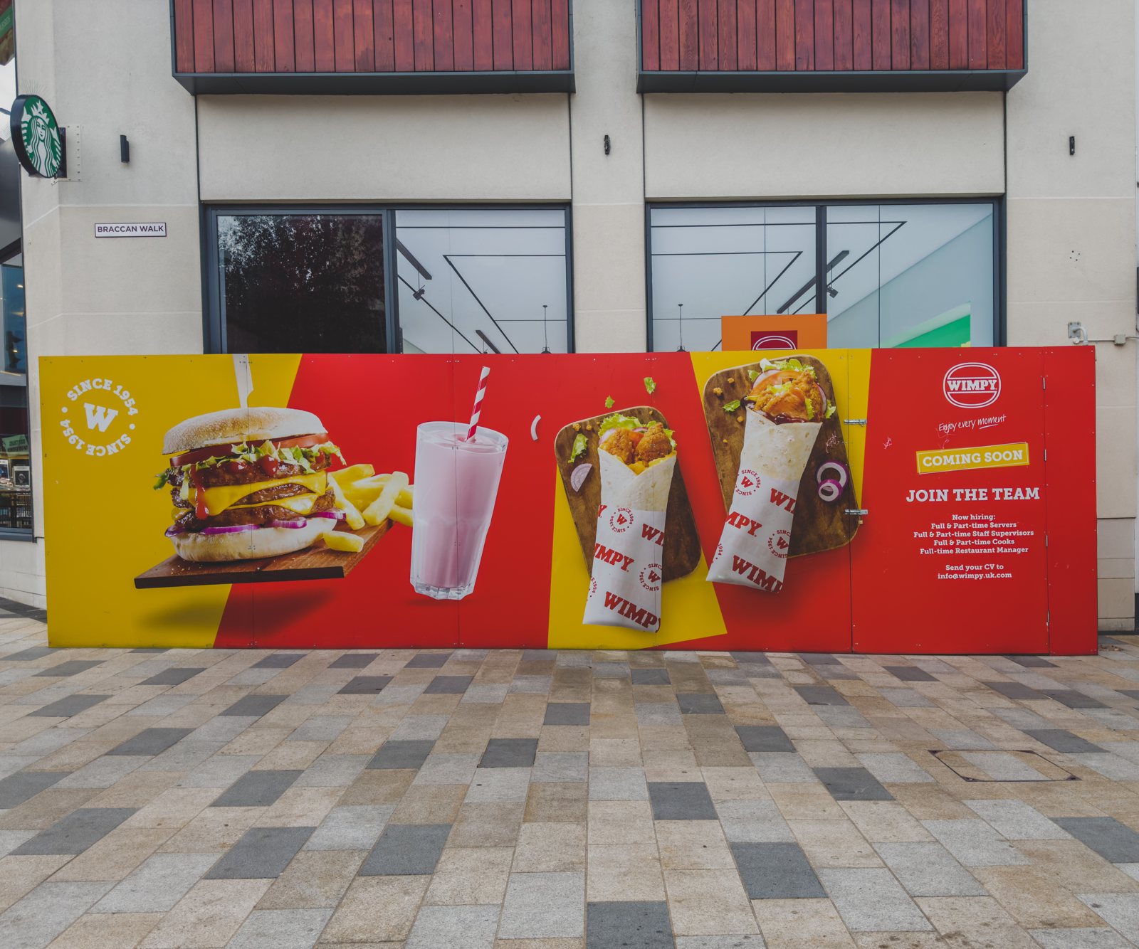 The full run of printed ACM panels across the storefront
